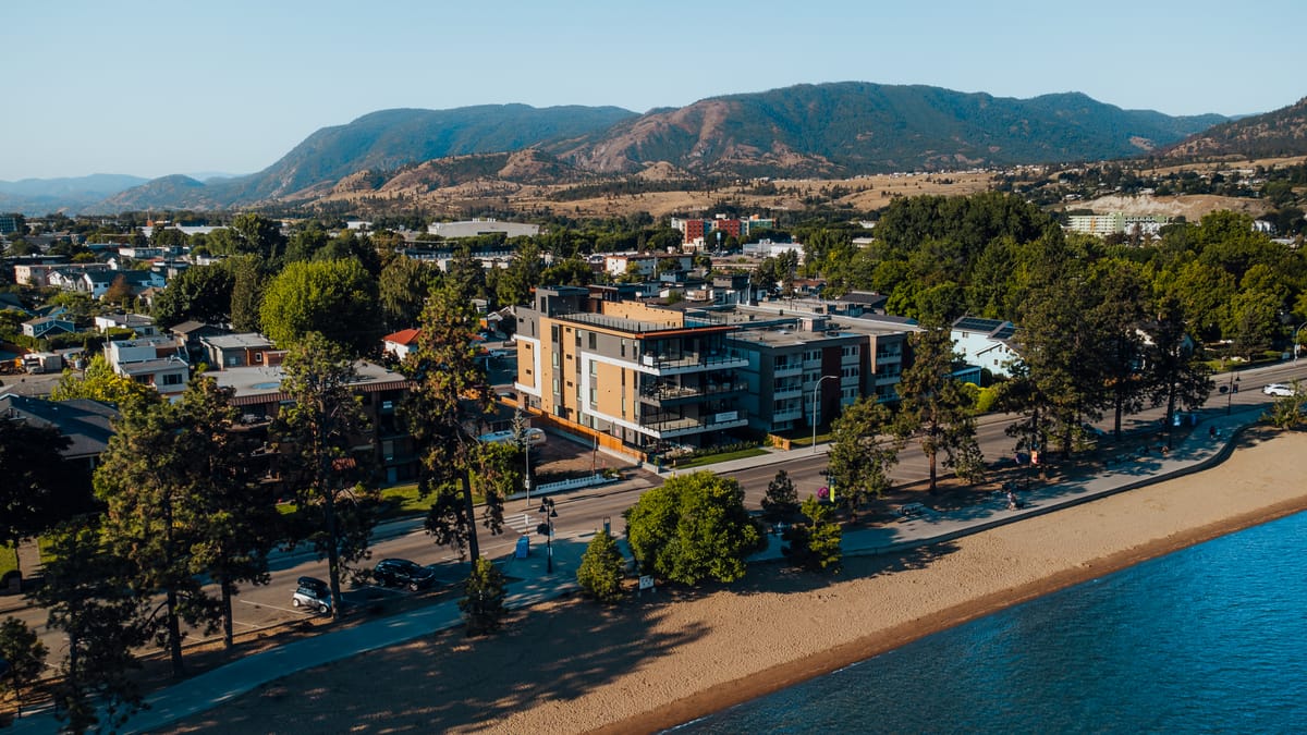 Legacy on Lakeshore from the air, sitting on the Penticton waterfront with the beach in front and the hills behind
