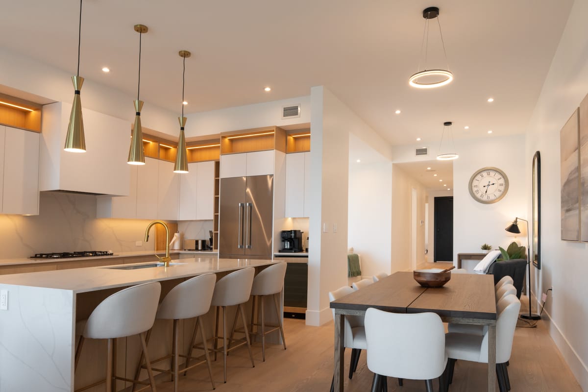 Open-plan kitchen and dining room with pendant lights over the island