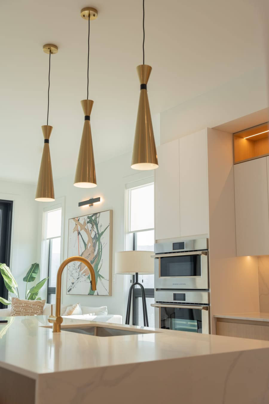 Brass kitchen tap on a quartz counter